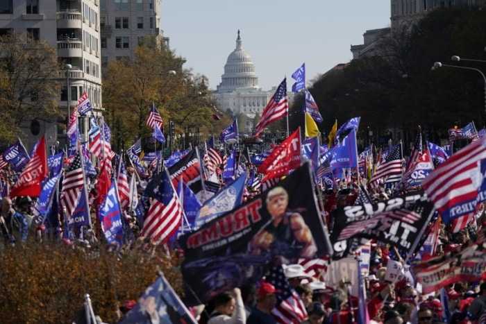 Biden ‘will be removed one way or another’: Alex Jones, Michael Flynn speak at pro-Trump march as rival protesters clash
