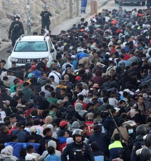 Ceuta overrun: Thousands of migrants charge through streets of Spanish enclave as police attempt to move them to official tent camp