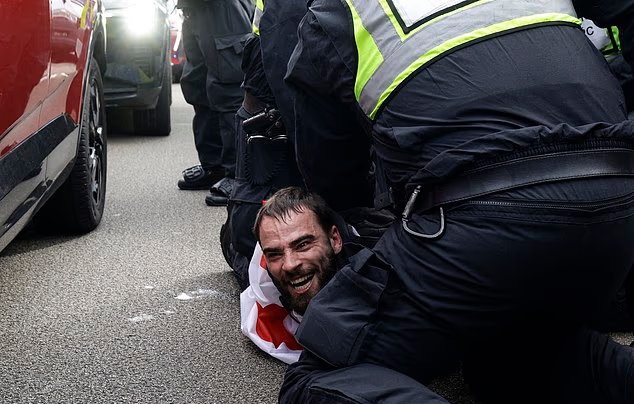 Police arrest anti-migrant protesters in angry clashes at Portsmouth demo after marchers were warned not to cover their faces