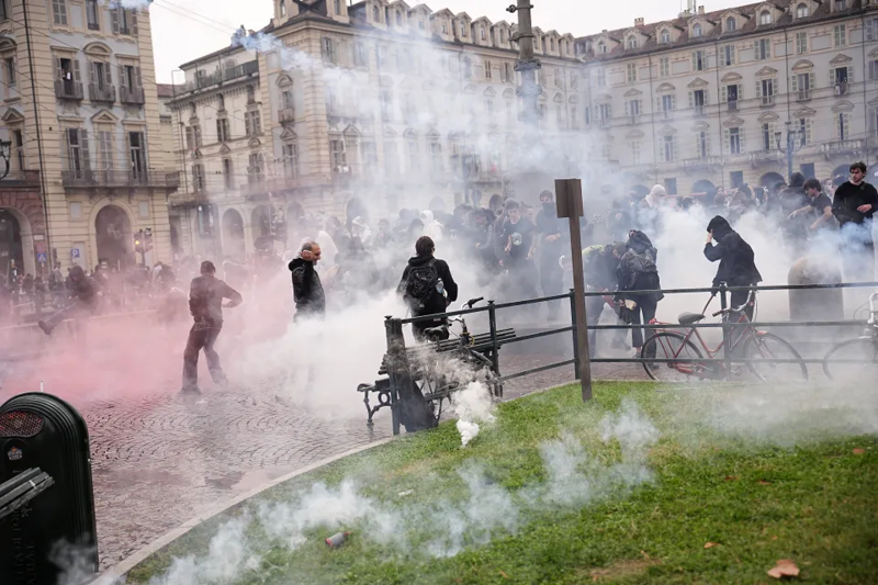 Thousands of masked teens clash with riot cops and hurl petrol bombs & firecrackers as school riots spread to Italy