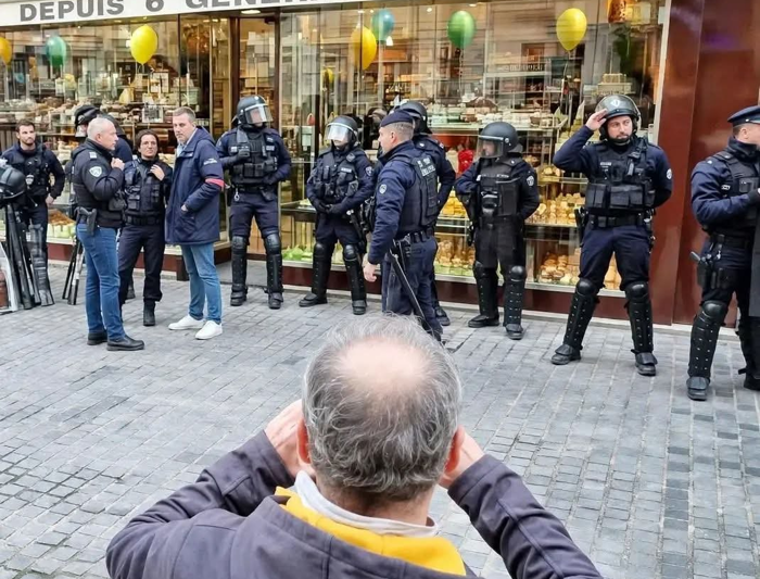 Let them eat cake! Emmanuel Macron’s family macaron shop was guarded by police ring of steel during riots… while other shops were left to burn